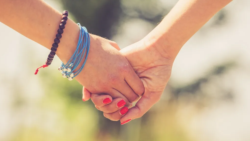 Holding hands with young person